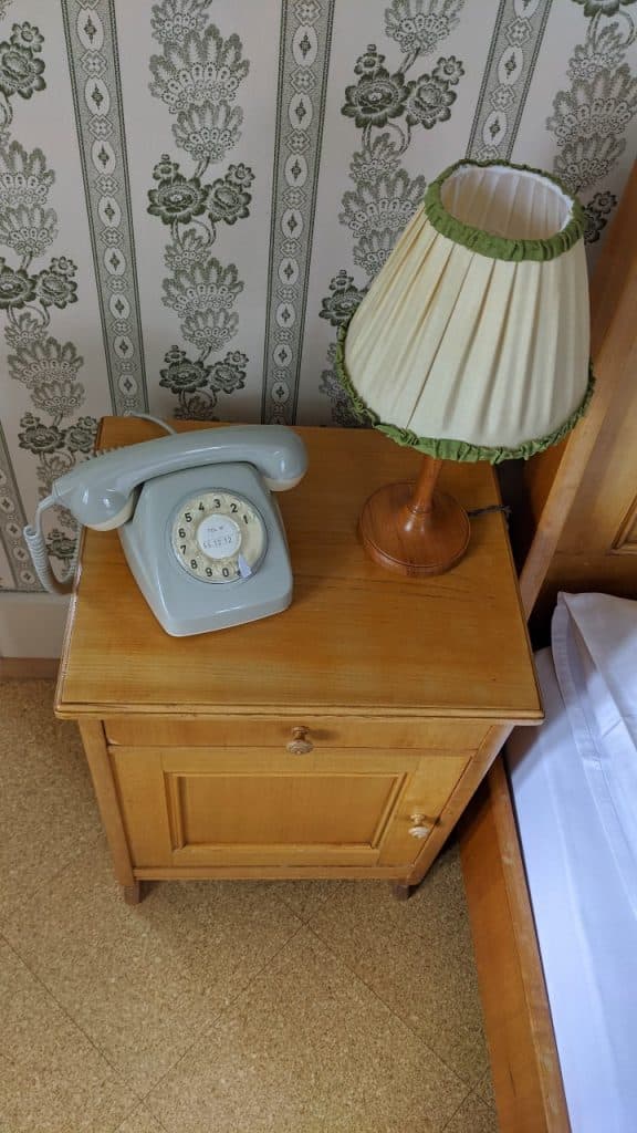 Old Swiss phone on bedside table in our room at Hotel Bellevue des Alpes in Switzerland