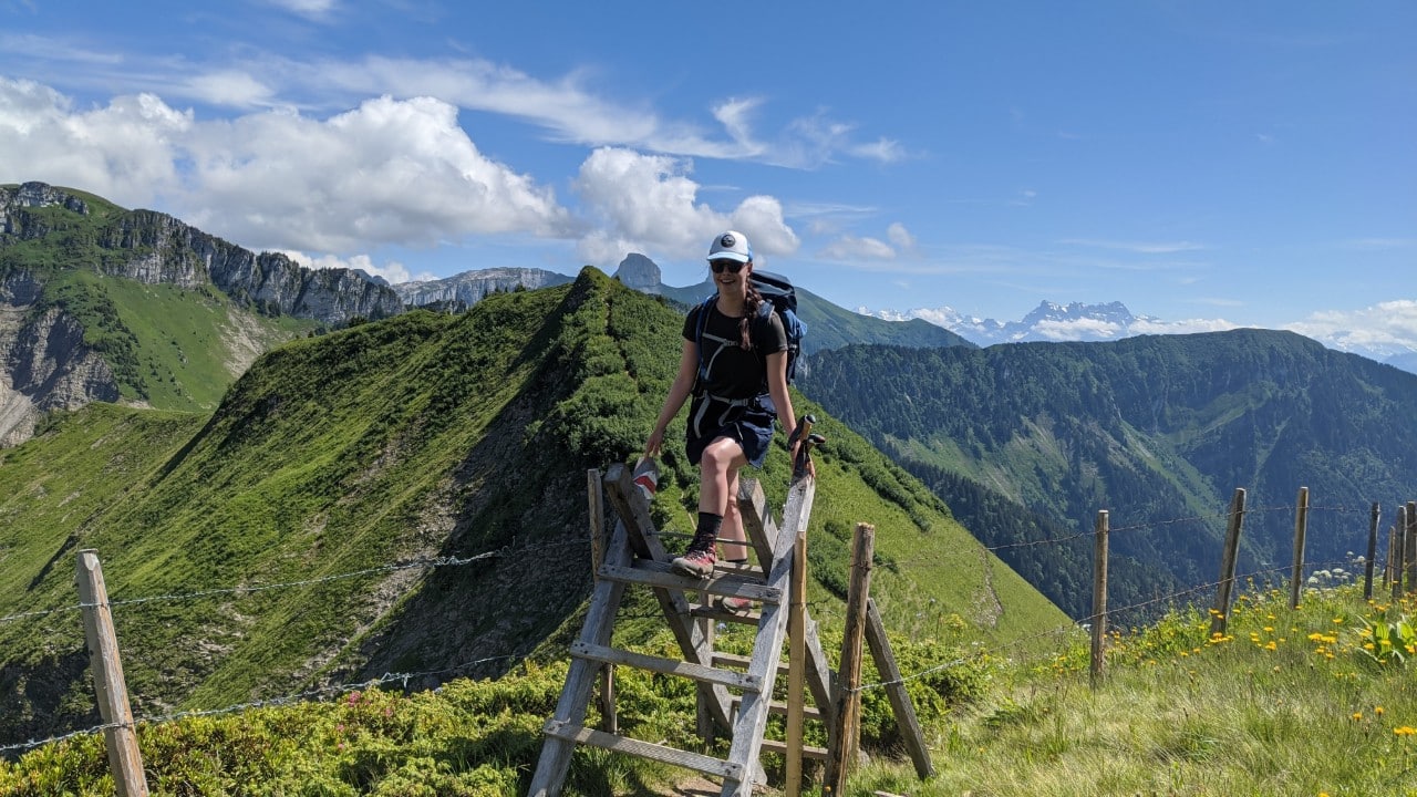 Solène climbing over a ladder on the hiking trail to Rochers-de-Naye