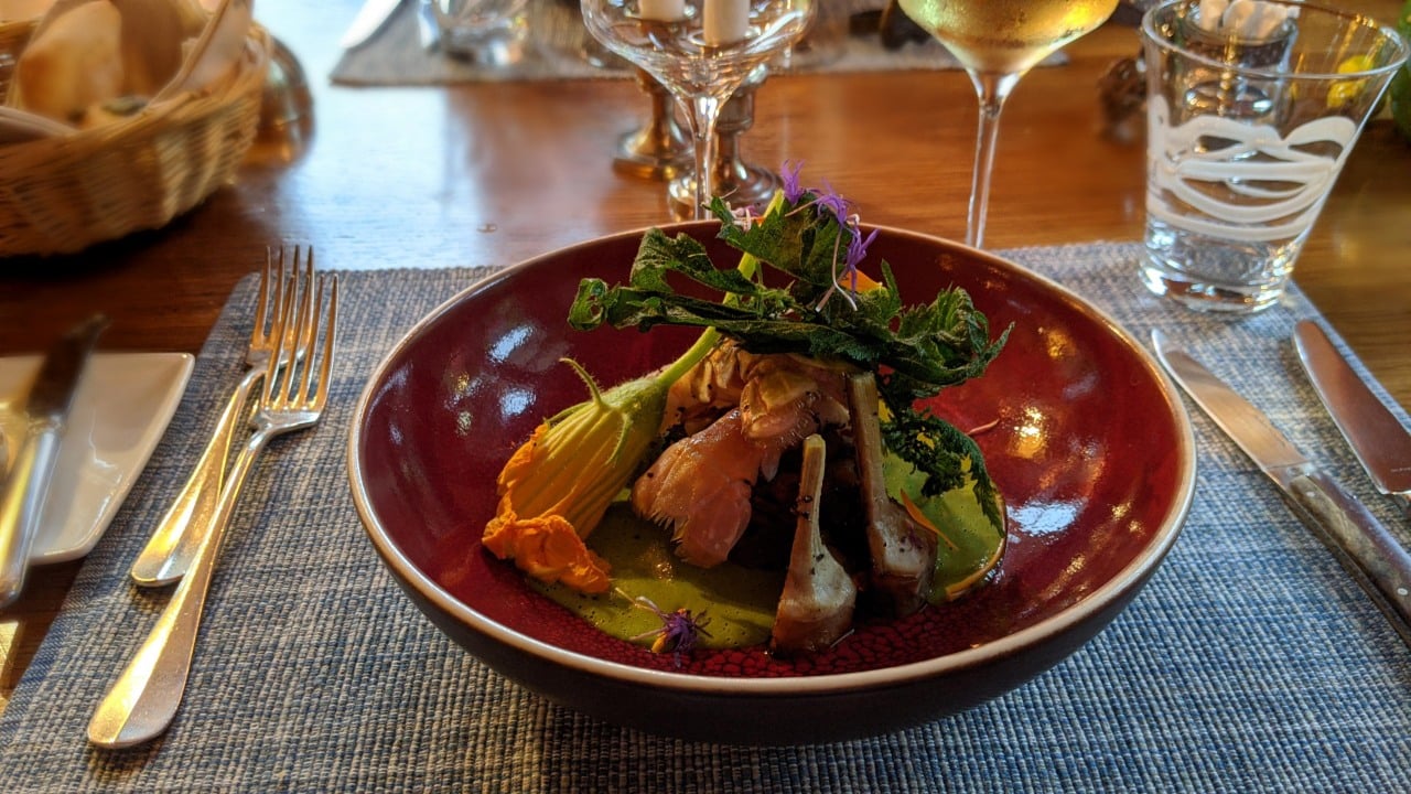 Lobster from Brittany with an artichoke on a bed of mediterranean vegetables at restaurant les jardins de la tour in Rossinière, Switzerland
