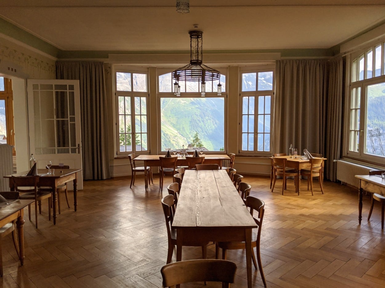 The Dining hall at hotel Regina Mürren with views to Jungfrau massif.