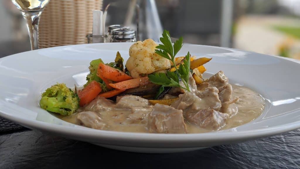 Boiled veal in horseradish sauce with vegetables
