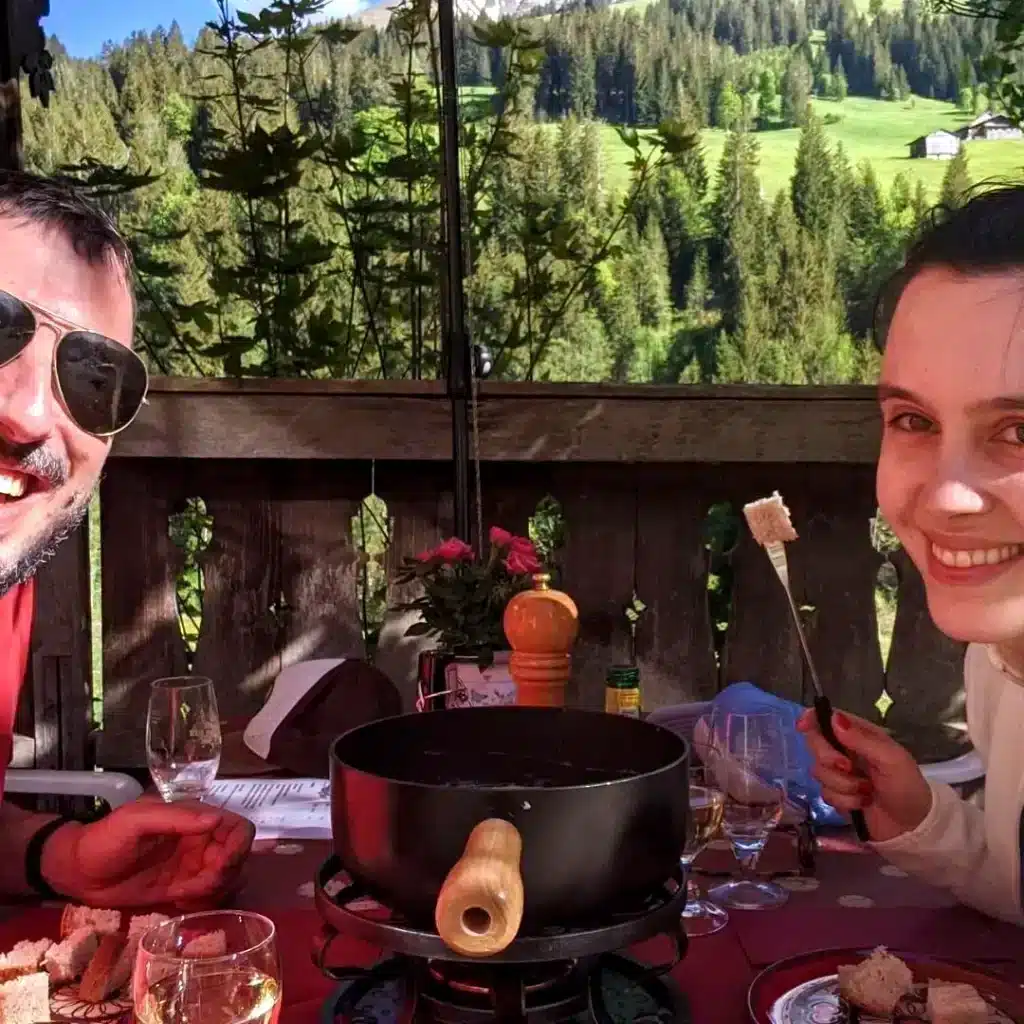 Solène and Matthias having fondue in restaurant Sunne Stuebli in Turbach bei Gstaad