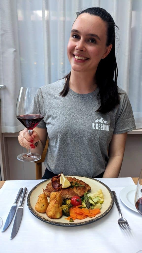 Solène enjoys the sponsor's plate with a glass of wine at Bahnhöfli Entlebuch